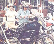 In Jogja, central Java, on the big BMW, Minou putting on her helmet, Adji his gloves